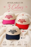 Put It On My Husband’s Tab Trucker Hat