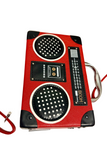 Red and black vintage-style radio purse with a strap on a white surface